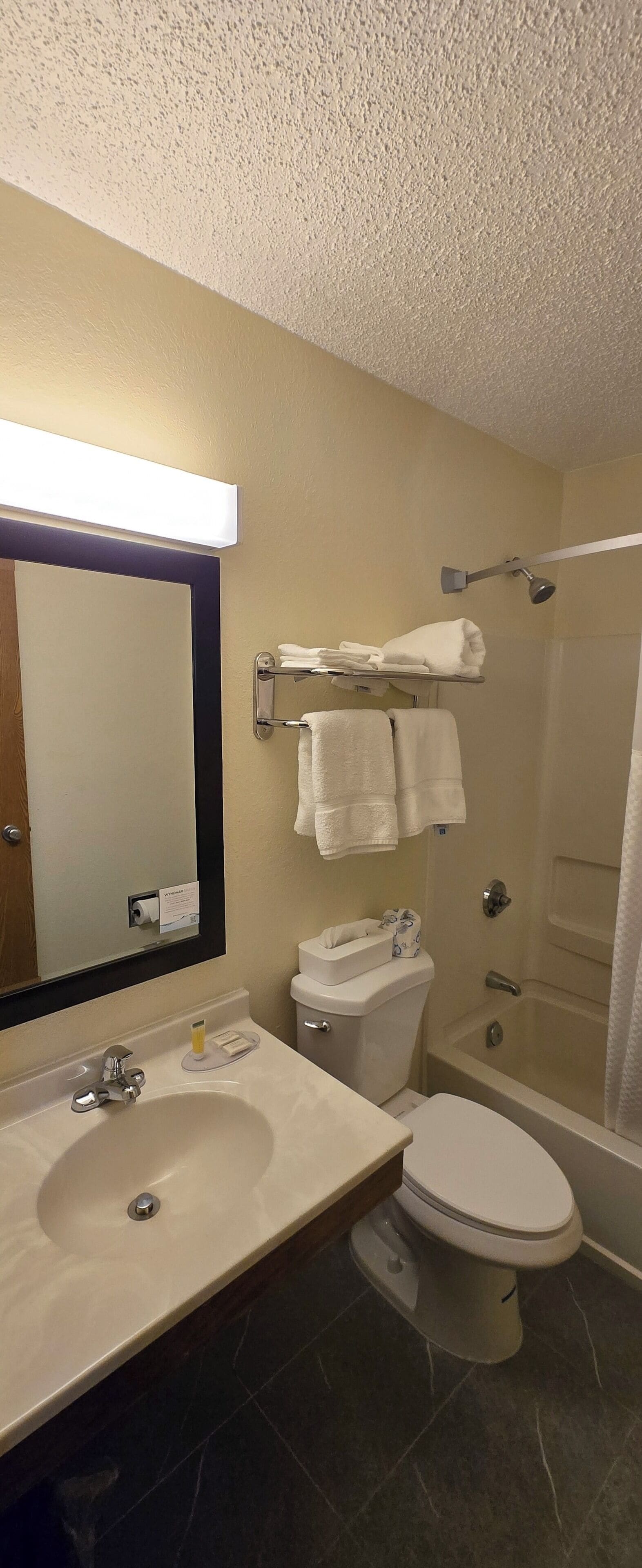 A bathroom with a sink, toilet, and bathtub.