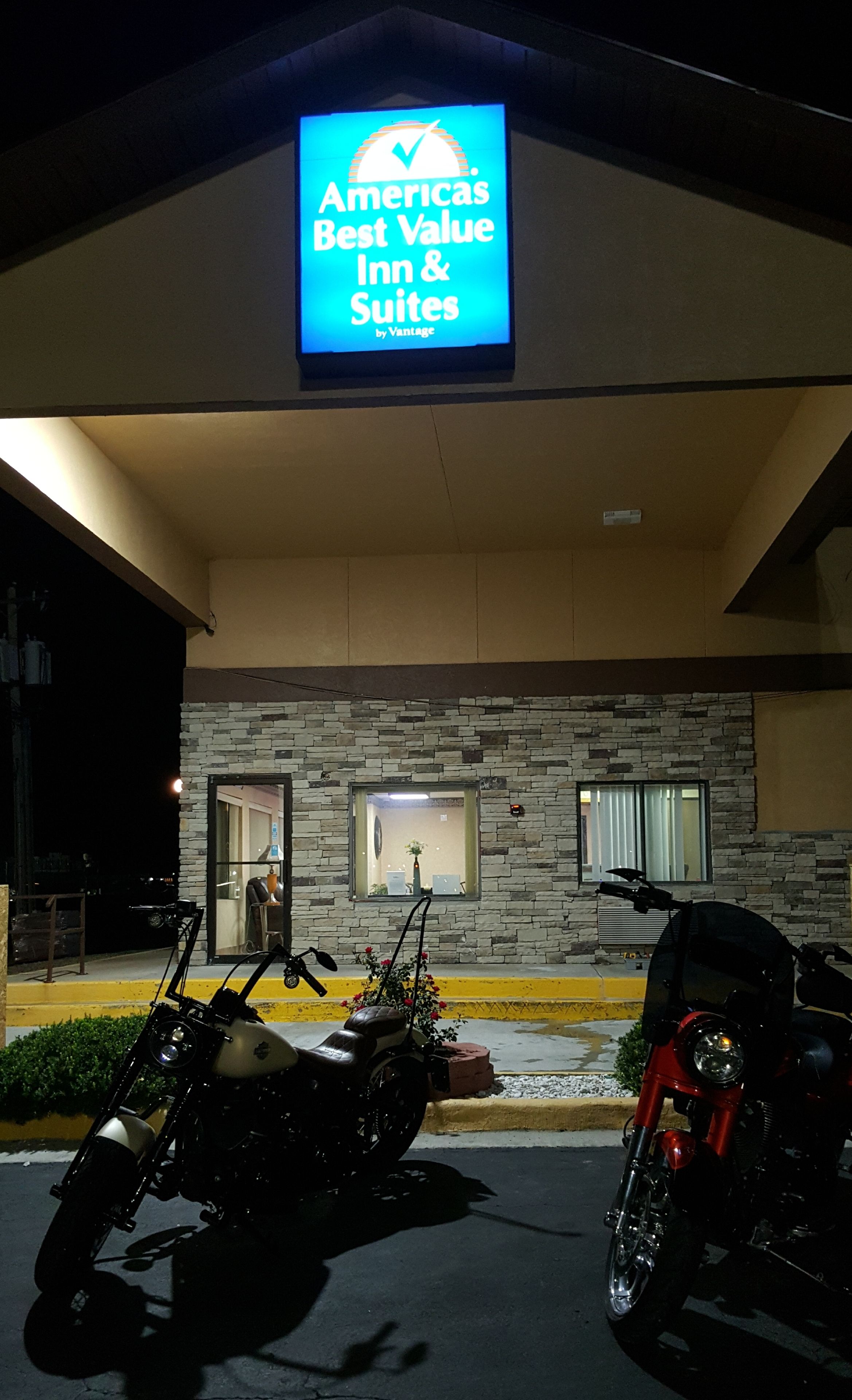 A hotel entrance with a sign for Americas Best Value Inn & Suites by Vantage.