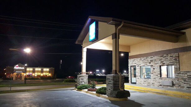 A gas station with a large sign, a covered area, and a building with a stone facade. - Americas Best Value Inn & Suites Harrisonville (Harrisonville)
