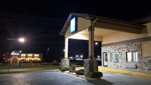 A gas station with a large sign, a covered area, and a building with a stone facade. - Americas Best Value Inn & Suites Harrisonville (Harrisonville)