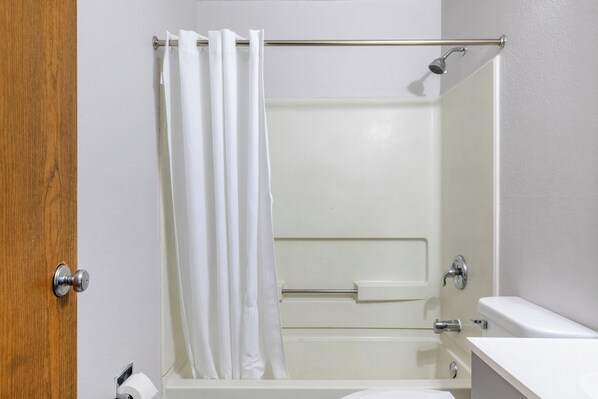 A bathroom with a bathtub, a shower, a toilet, and a sink.