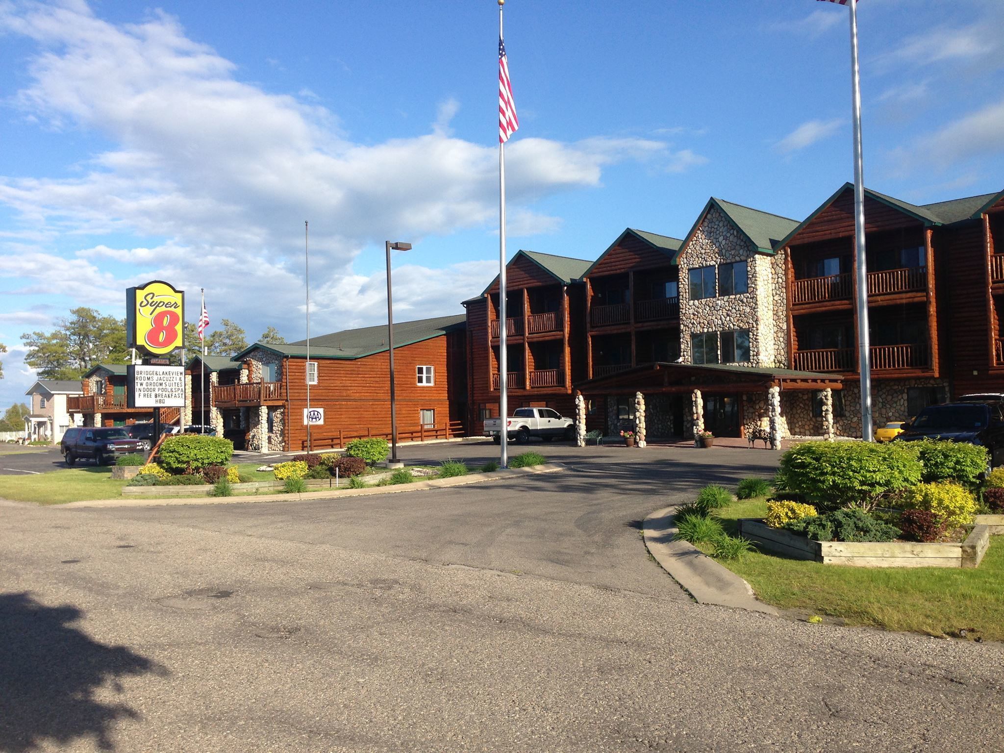 A lodge with a stone facade, multiple balconies, and a Super 8 sign indicating a motel.