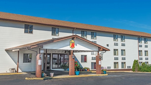 A motel with a covered entrance, a sign indicating it is Super 8, and a parking lot in front. - Super 8 by Wyndham Sullivan (Sullivan)
