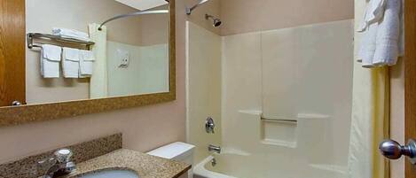A bathroom with a sink, toilet, bathtub, and a shower.