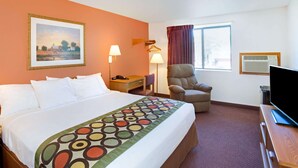 A hotel room with a large bed, a chair, a desk with a TV, a lamp, and a painting on the wall. - Super 8 by Wyndham Aberdeen East (Aberdeen)