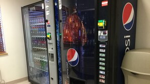 Two vending machines, one with a Pepsi logo and another with a Coca-Cola logo, in a tiled area. - Super 8 by Wyndham Aberdeen East (Aberdeen)