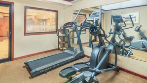 A gym with treadmills, elliptical machines, and a mirrored wall. - Super 8 by Wyndham Tilton/Lake Winnipesaukee (Tilton)