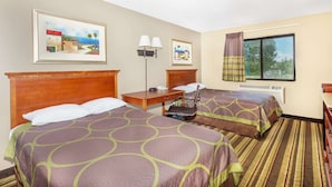 A hotel room with two beds, a desk, a chair, a lamp, and a window with curtains. - Super 8 by Wyndham Tilton/Lake Winnipesaukee (Tilton)