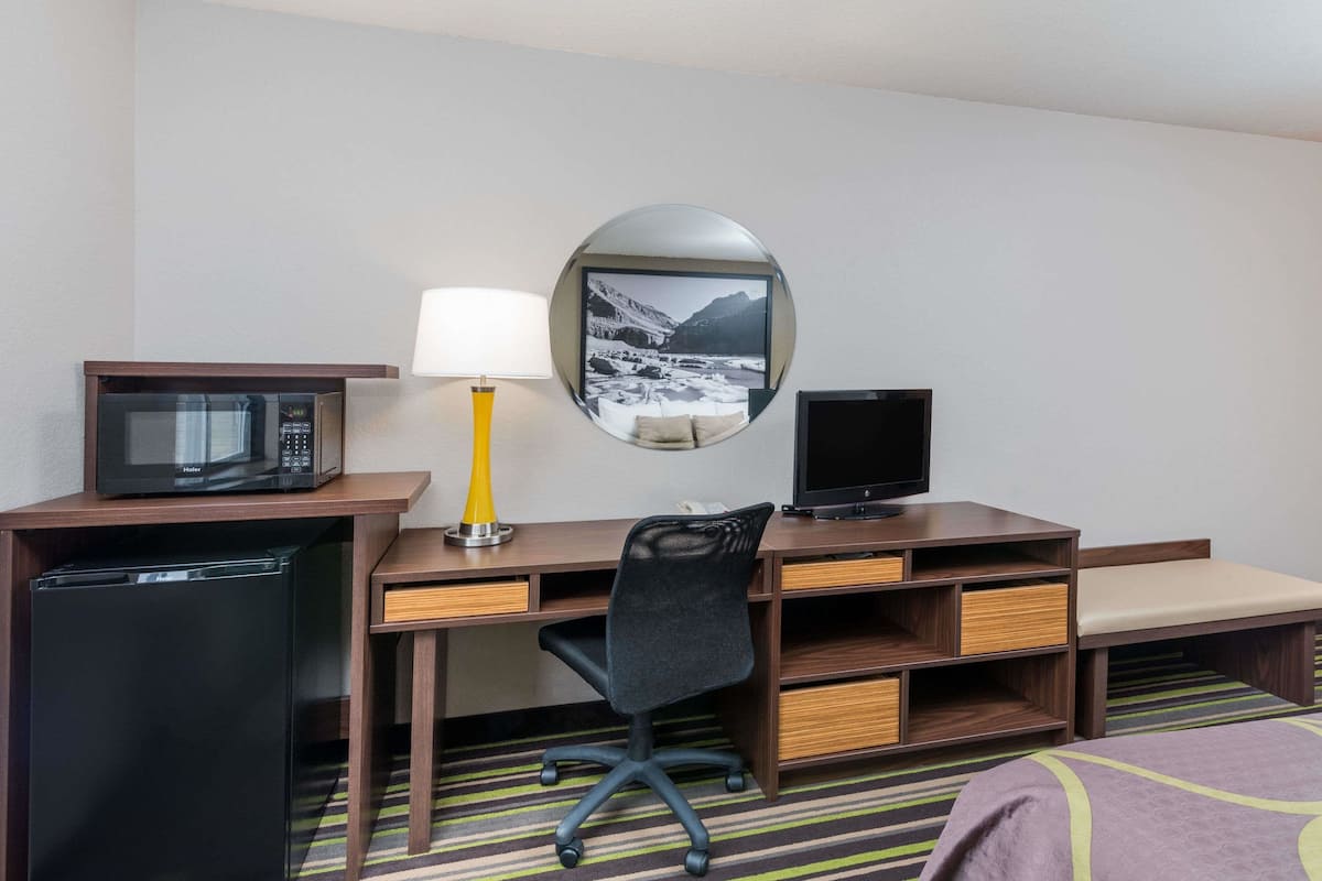 Desk, laptop workspace, blackout drapes, iron/ironing board