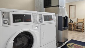 A laundry area with multiple washing machines and a commercial dryer. - Super 8 by Wyndham Kalispell Glacier National Park (Kalispell)