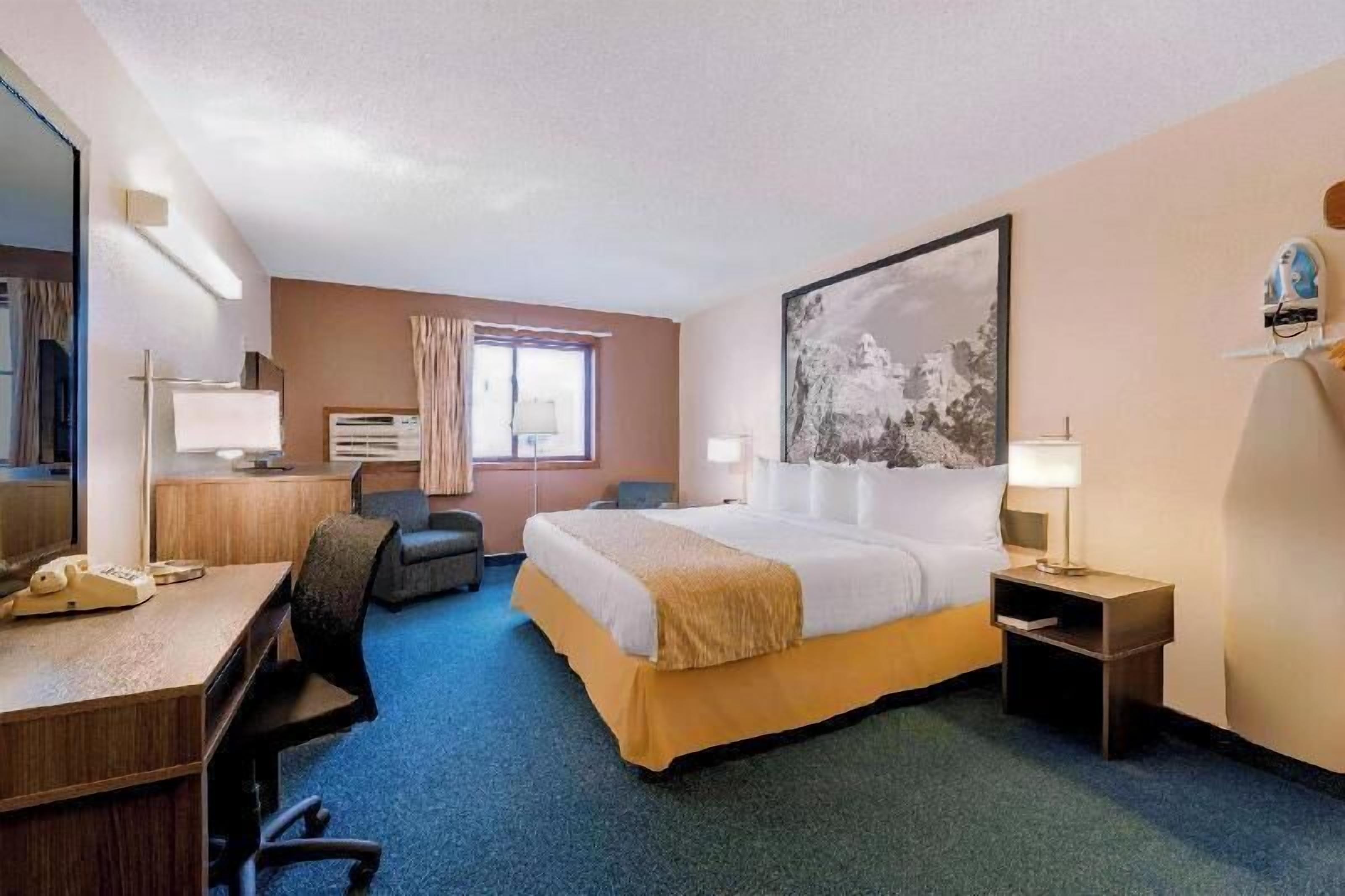Premium bedding, desk, laptop workspace, blackout drapes