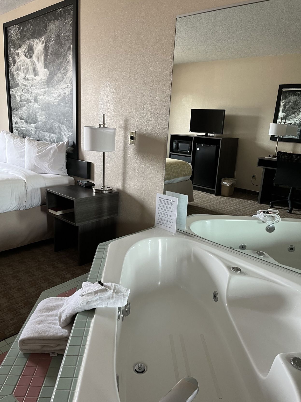 Premium bedding, desk, laptop workspace, blackout drapes