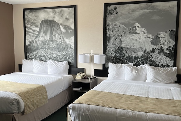Premium bedding, desk, laptop workspace, blackout drapes