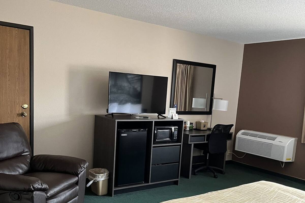 Premium bedding, desk, laptop workspace, blackout drapes