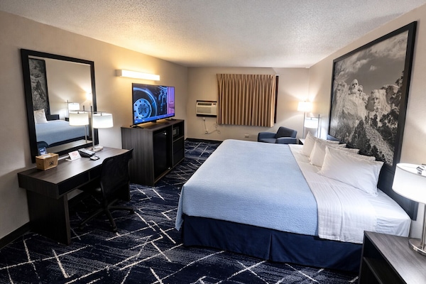 Premium bedding, desk, laptop workspace, blackout drapes
