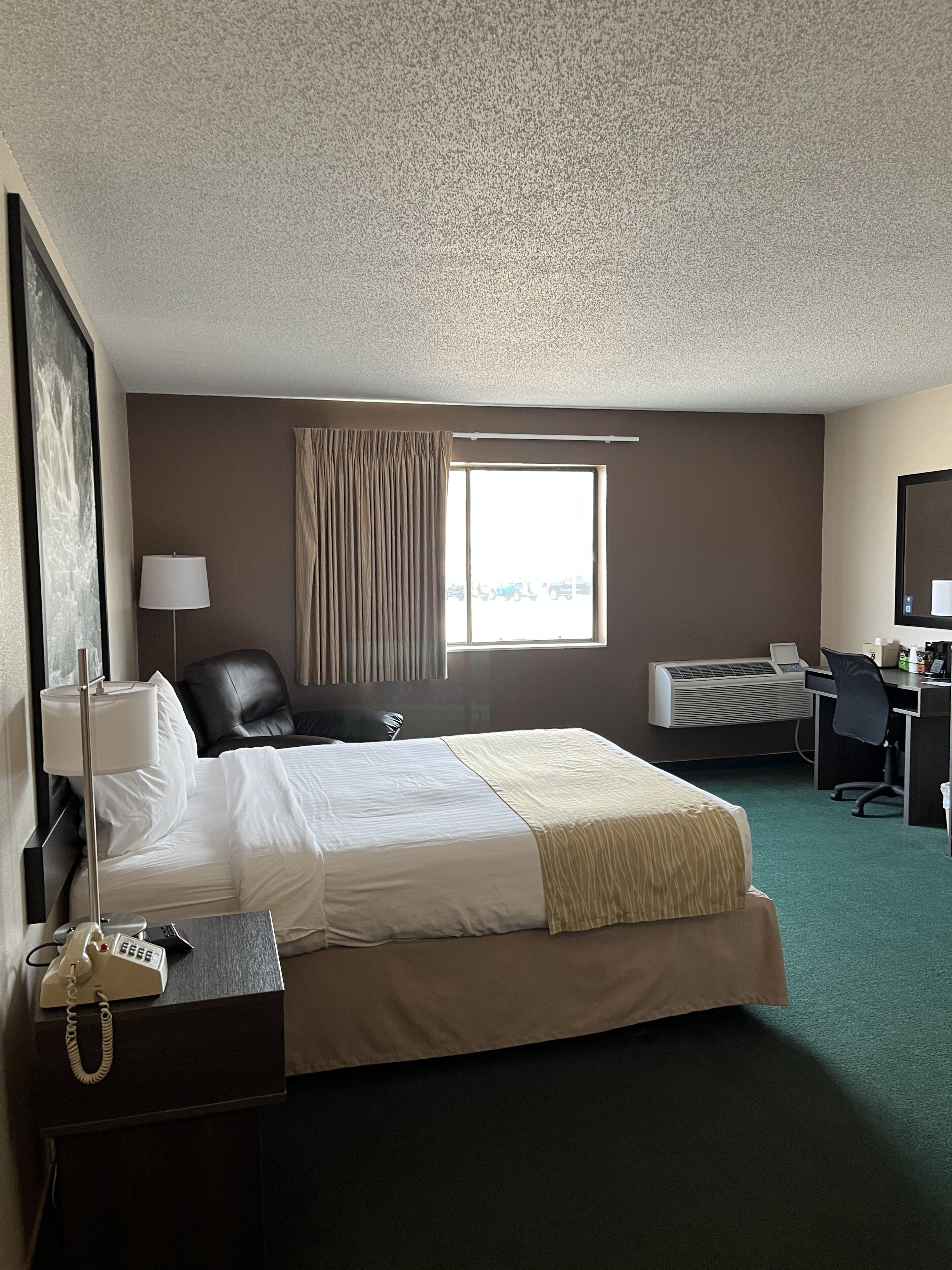 Premium bedding, desk, laptop workspace, blackout drapes