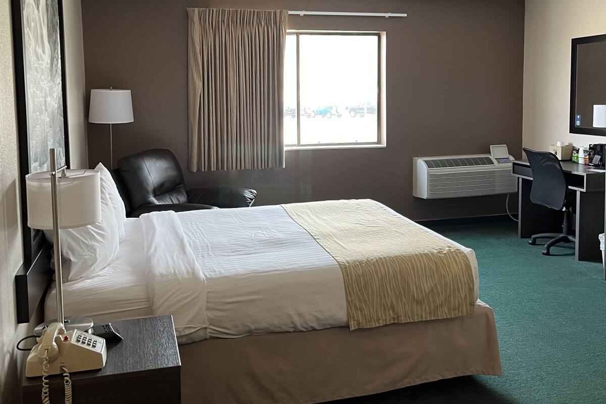 Premium bedding, desk, laptop workspace, blackout drapes