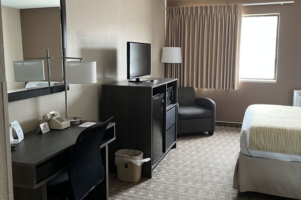 Premium bedding, desk, laptop workspace, blackout drapes
