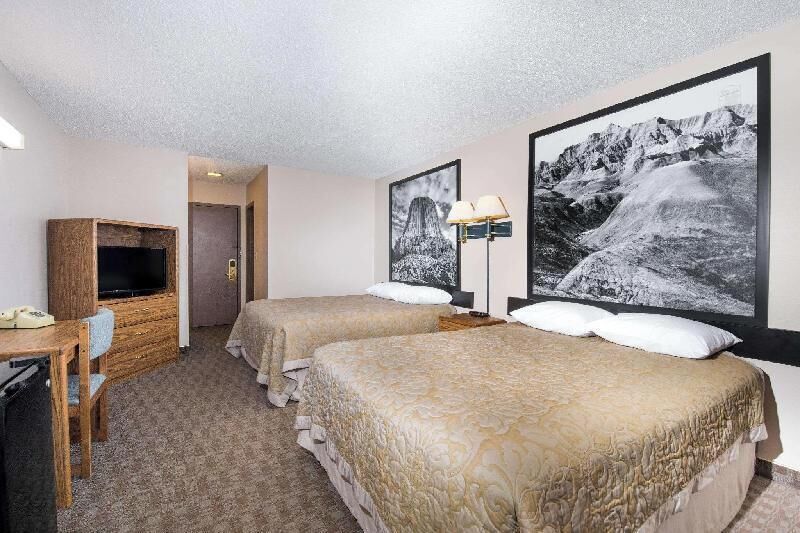 Premium bedding, desk, laptop workspace, blackout drapes