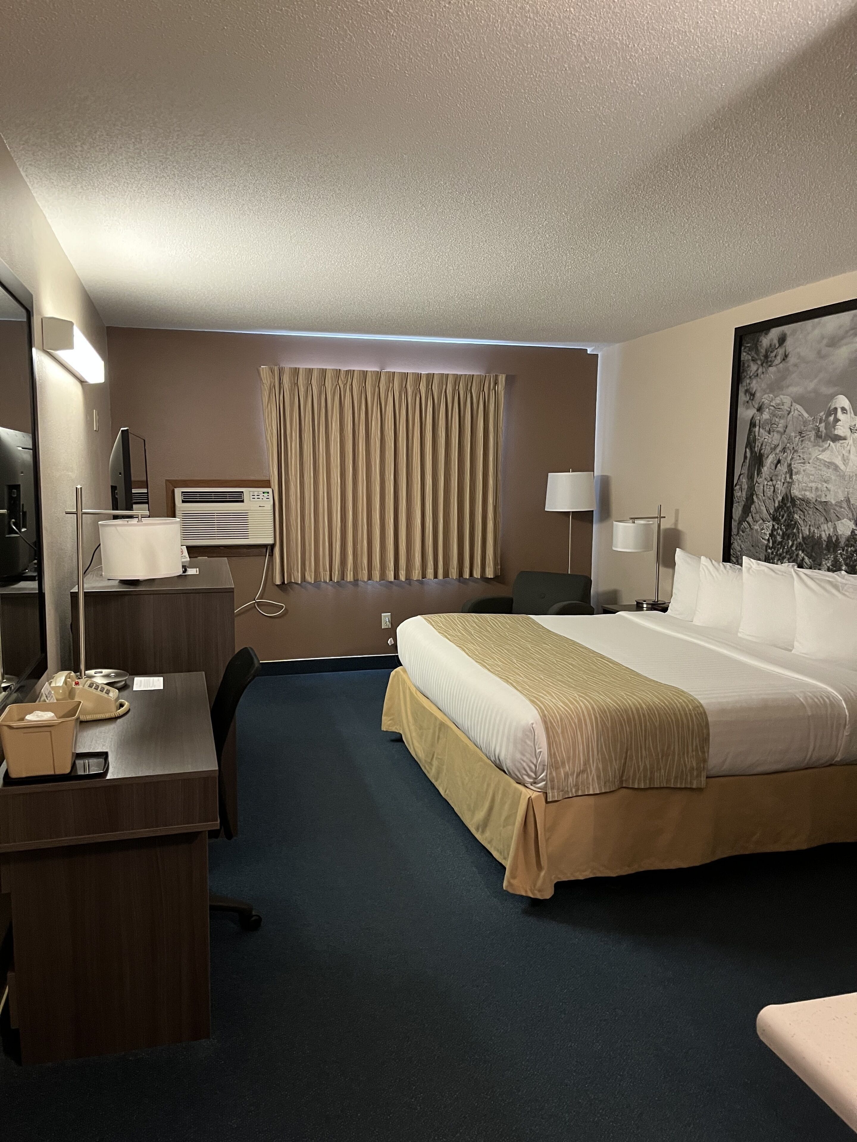 Premium bedding, desk, laptop workspace, blackout drapes