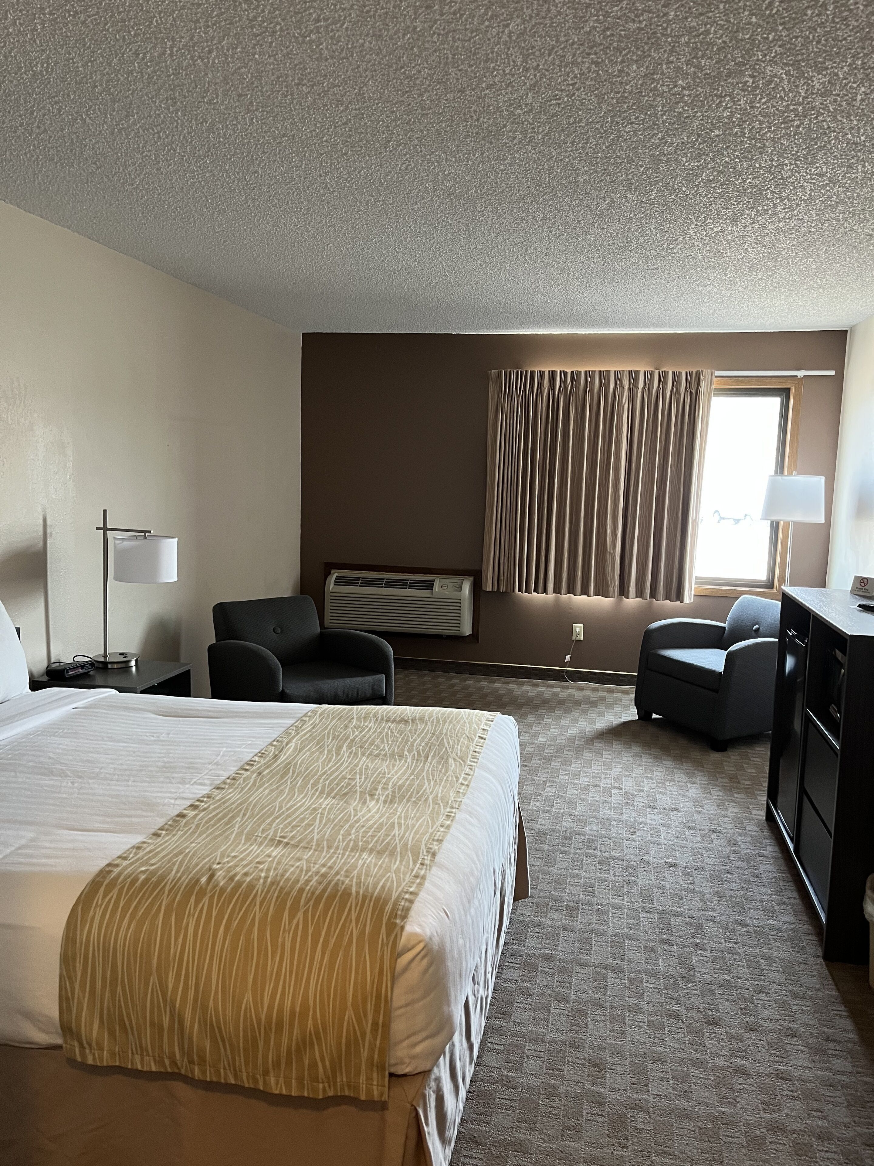 Premium bedding, desk, laptop workspace, blackout drapes