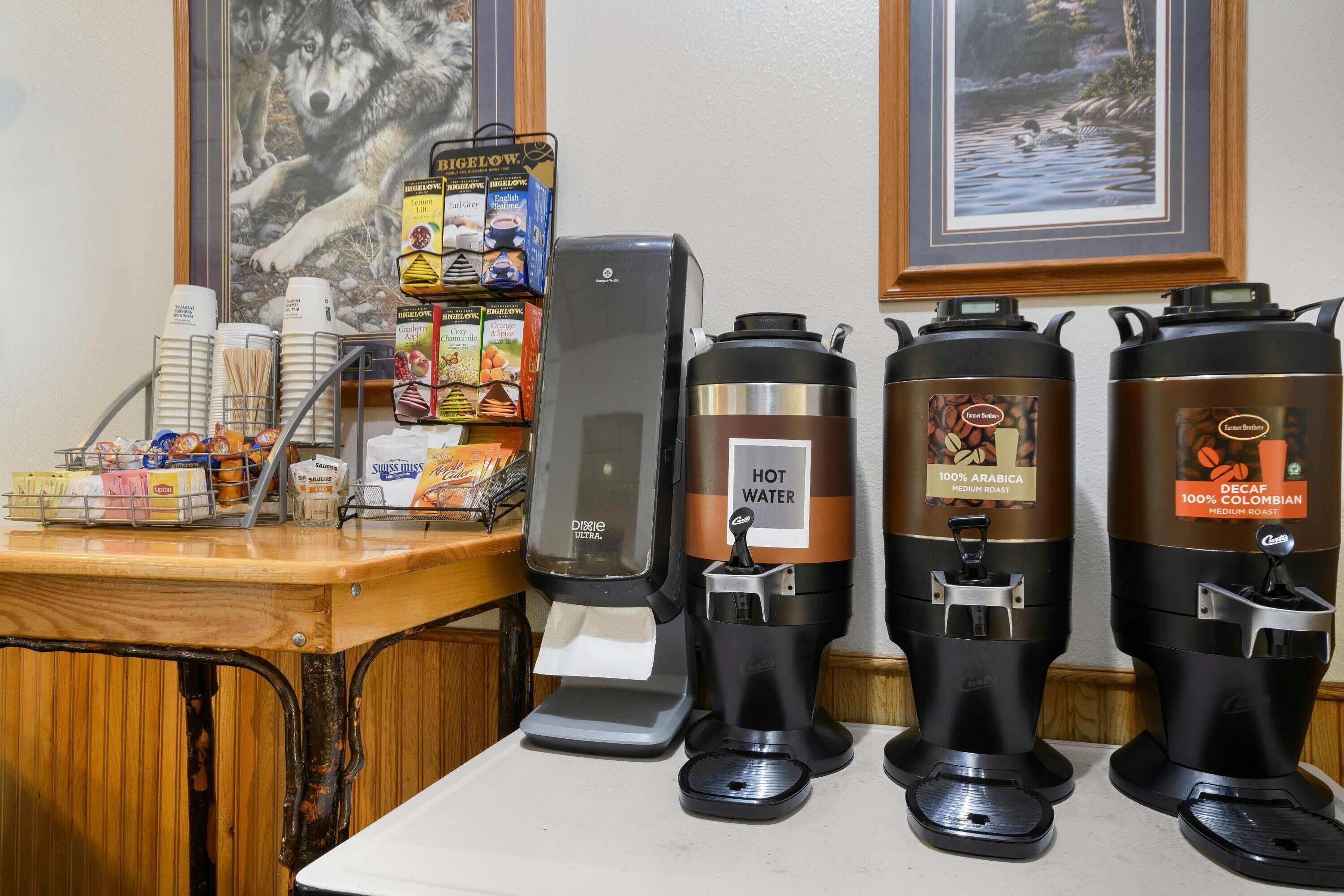 A coffee station with a coffee machine, a hot water dispenser, and a coffee grinder.