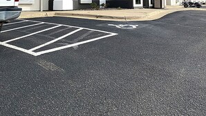 A hotel with a blue roof and a sign reading "CORATEI". - Coratel Inn & Suites By Jasper Northfield (Northfield)