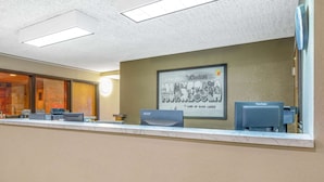 A reception desk with a framed sign, a ViewSonic monitor, and a printer. - Super 8 by Wyndham Duluth (Duluth)