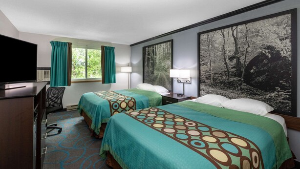 A hotel room with two beds, a desk, and a television. - Super 8 by Wyndham Duluth (Duluth)