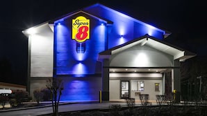 A Super 8 hotel with a prominent 'Super 8' sign, a modern architectural design, and a well-lit entrance. - Super 8 by Wyndham Charlottesville (Charlottesville)