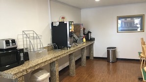 Una kitchenette equipada con microondas, tostadora y cafetera.