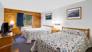 A room with two beds, wooden walls, a window, a desk with a computer, and a lamp. - Super 8 by Wyndham Lake George/Warrensburg Area (Lake George)