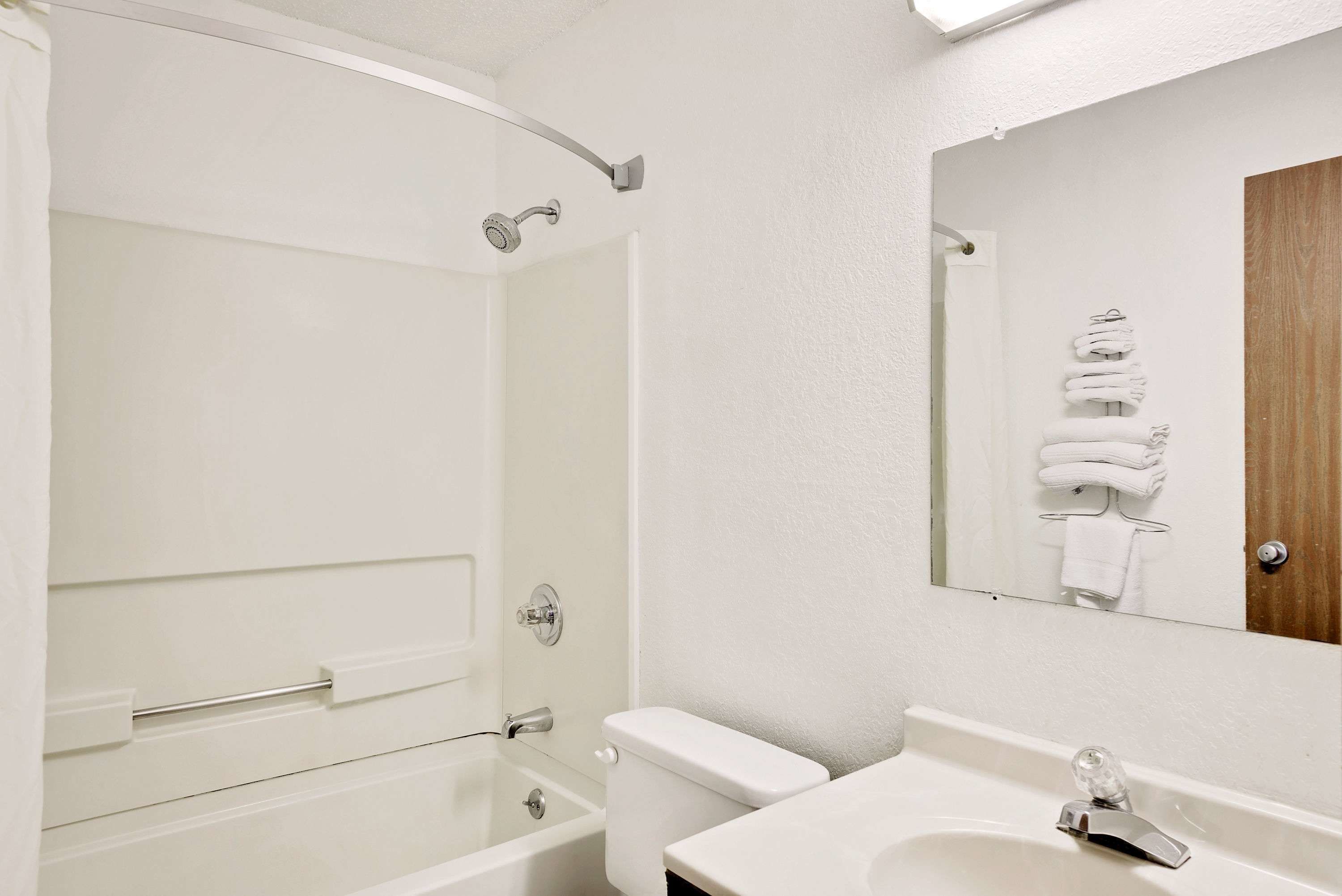 A bathroom with a bathtub, toilet, and sink.