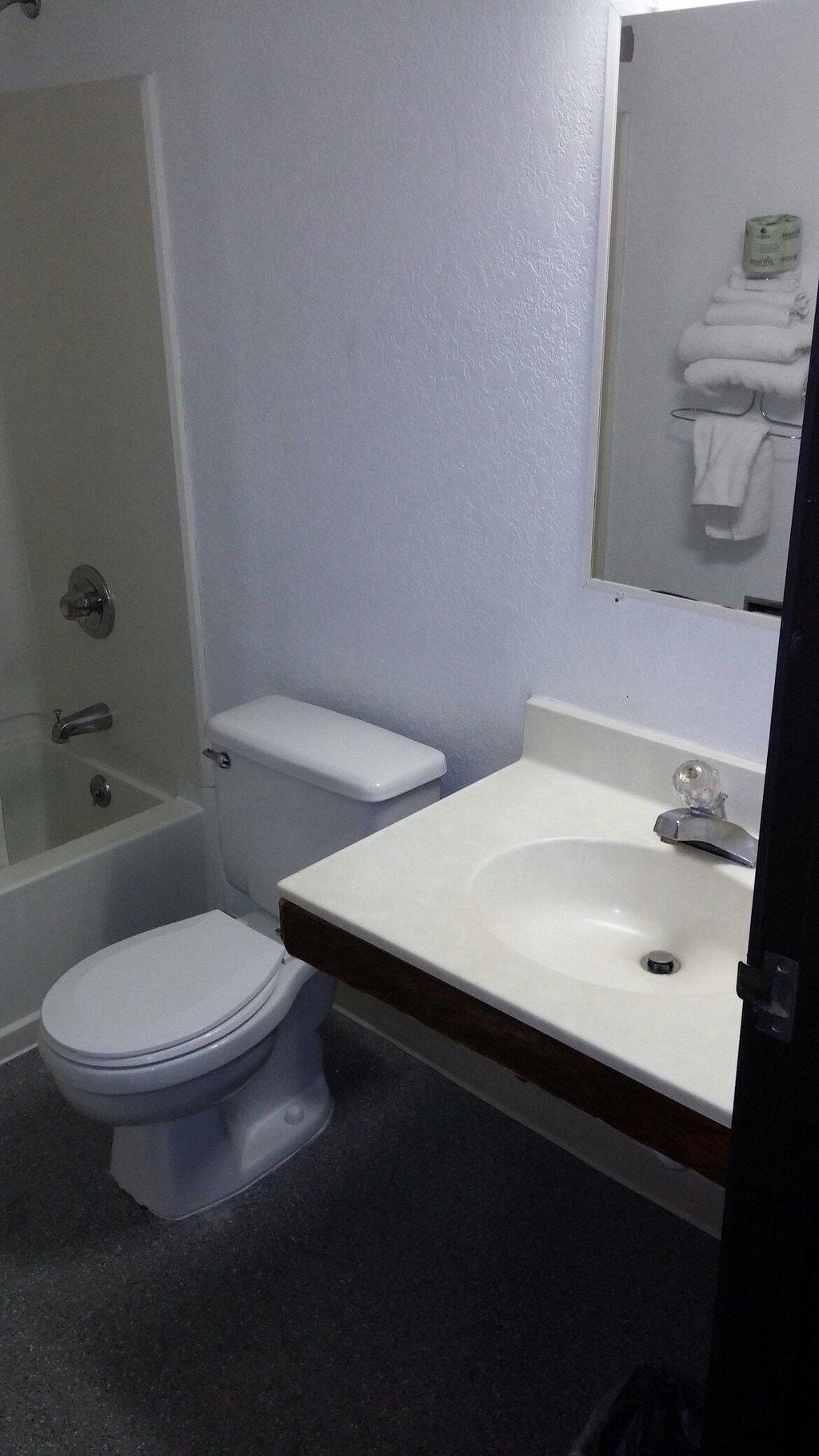 A bathroom with a toilet, a sink, and a bathtub.