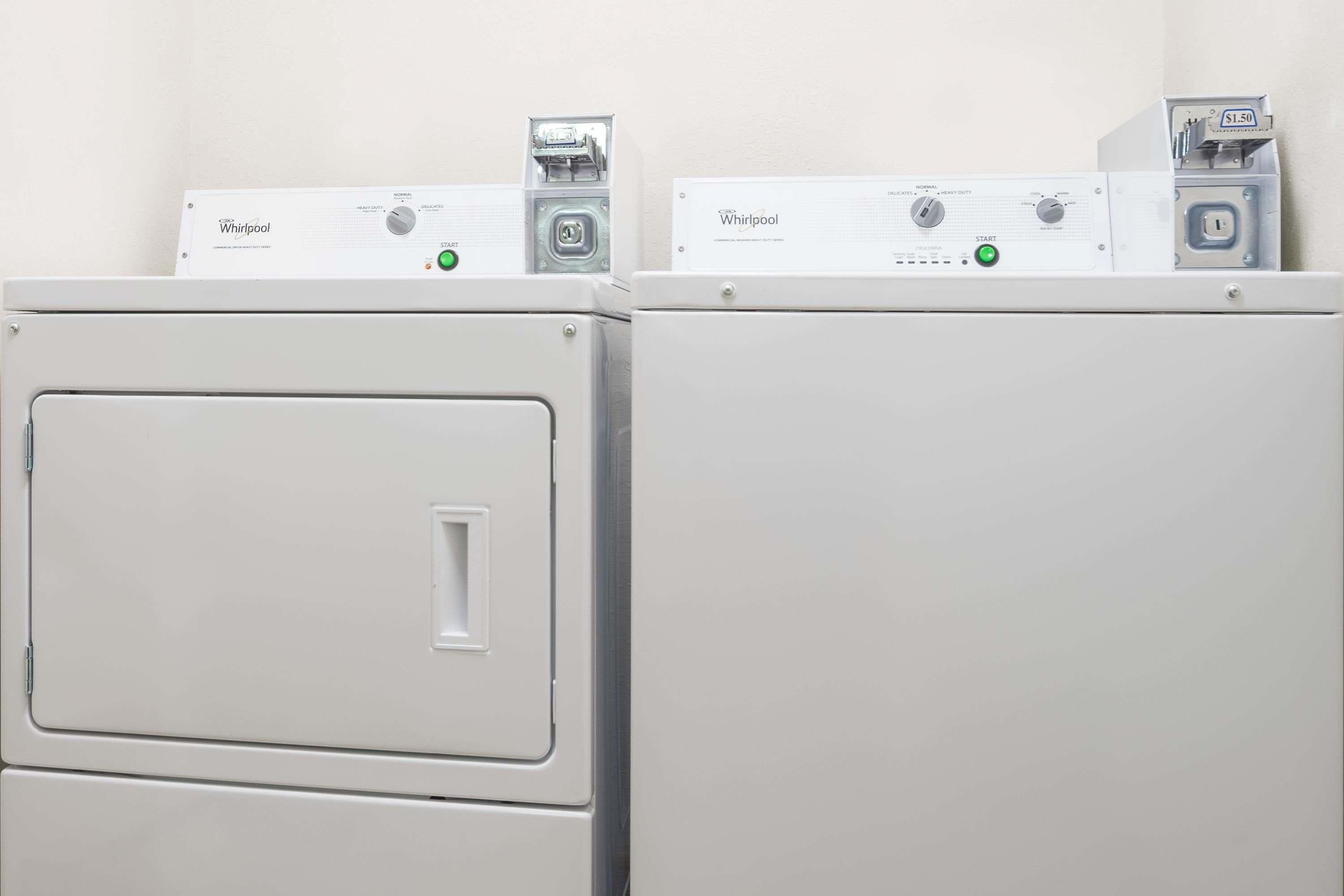 Two stacked Whirlpool appliances, likely a washer and dryer, in a laundry room.