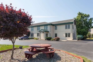 A two-story building with a green roof and multiple windows. - Super 8 by Wyndham Harrisburg Hershey West (Harrisburg)