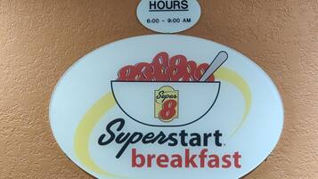 A wall sign for Superstart breakfast with operating hours from 6:00 to 9:00 AM.