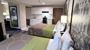 A hotel room with two beds, a kitchenette, a bathroom, and a large mirror. - Super 8 by Wyndham Logan (Logan)
