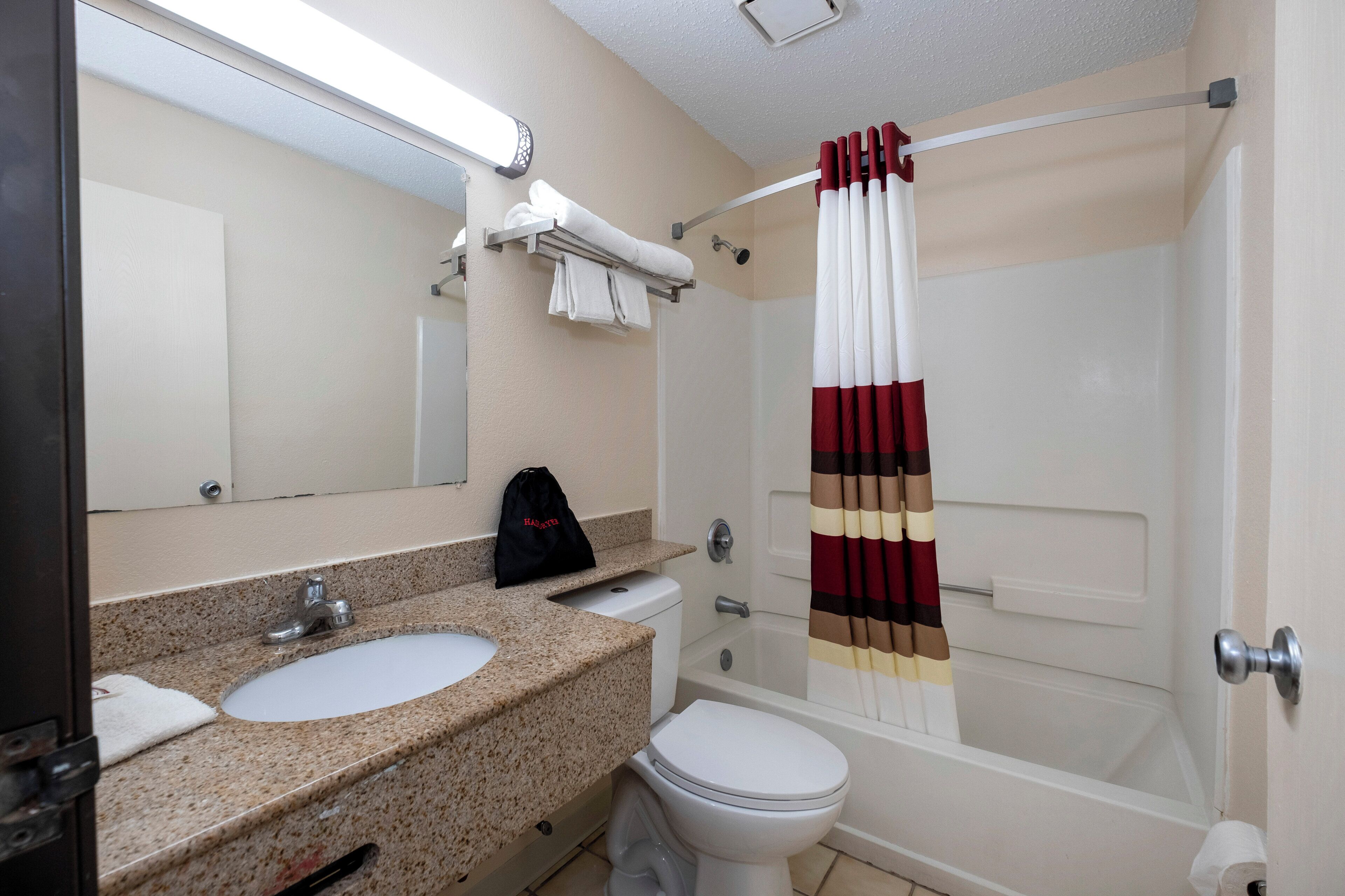 A bathroom with a sink, toilet, and shower.