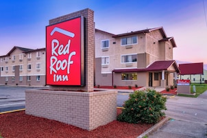 A Red Roof Inn with a prominent red sign, brick exterior, and multiple windows.