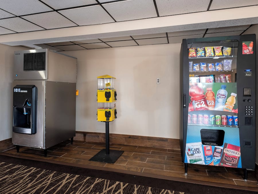 A vending machine and an ice dispenser in a hotel lobby.