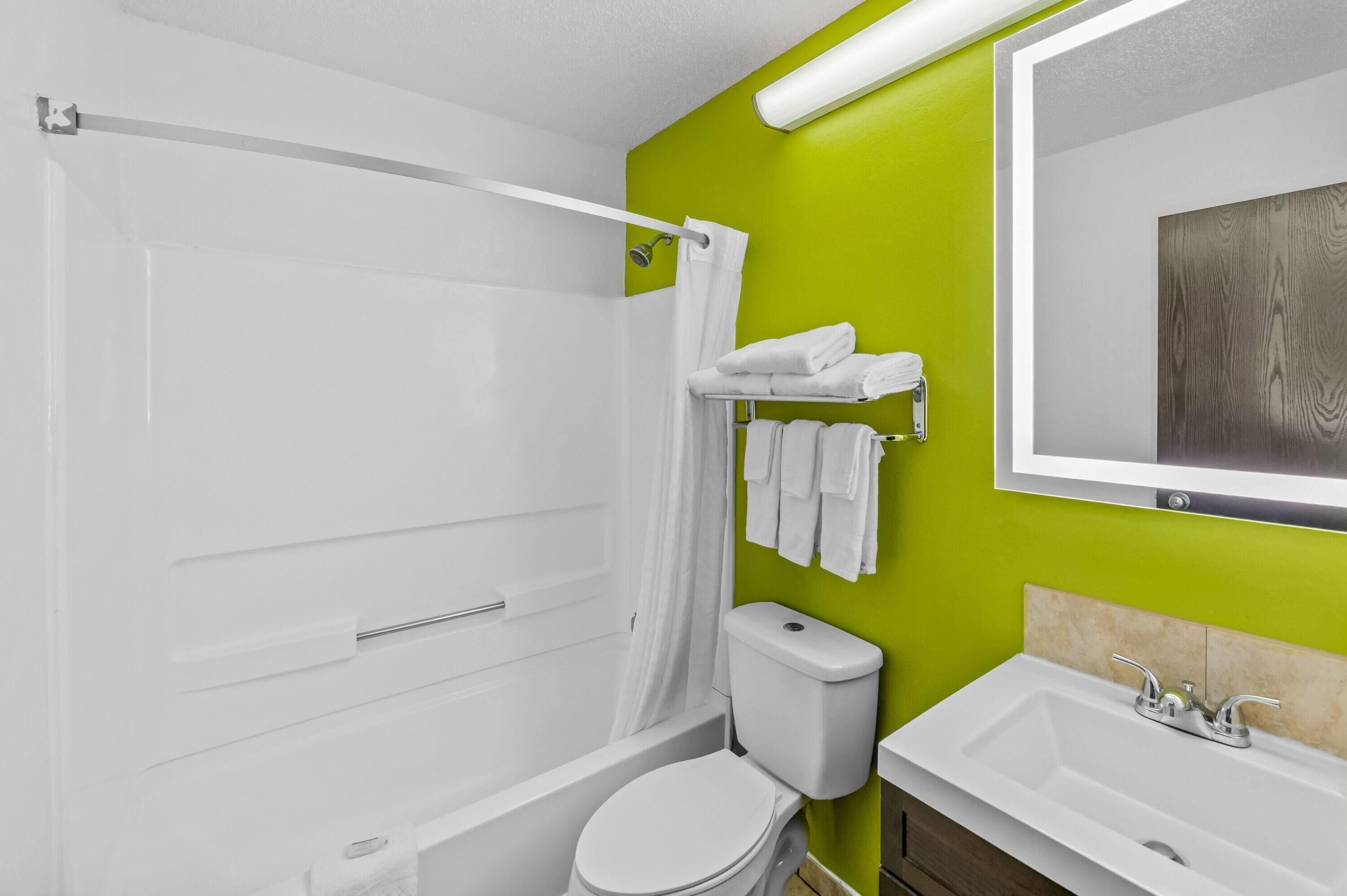 A bathroom with a shower, toilet, and sink.