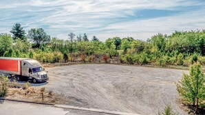 A large, open parking area with a parked truck. - Super 8 by Wyndham Georgetown (Georgetown)