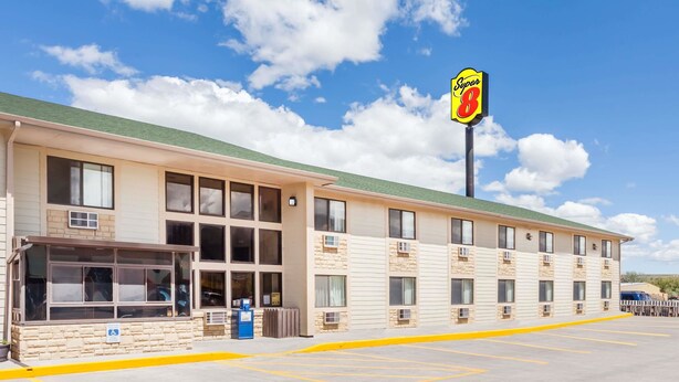 A Super 8 motel with a row of rooms, a drive-up window, and a parking lot. - Super 8 by Wyndham Livingston Yellowstone (Livingston)
