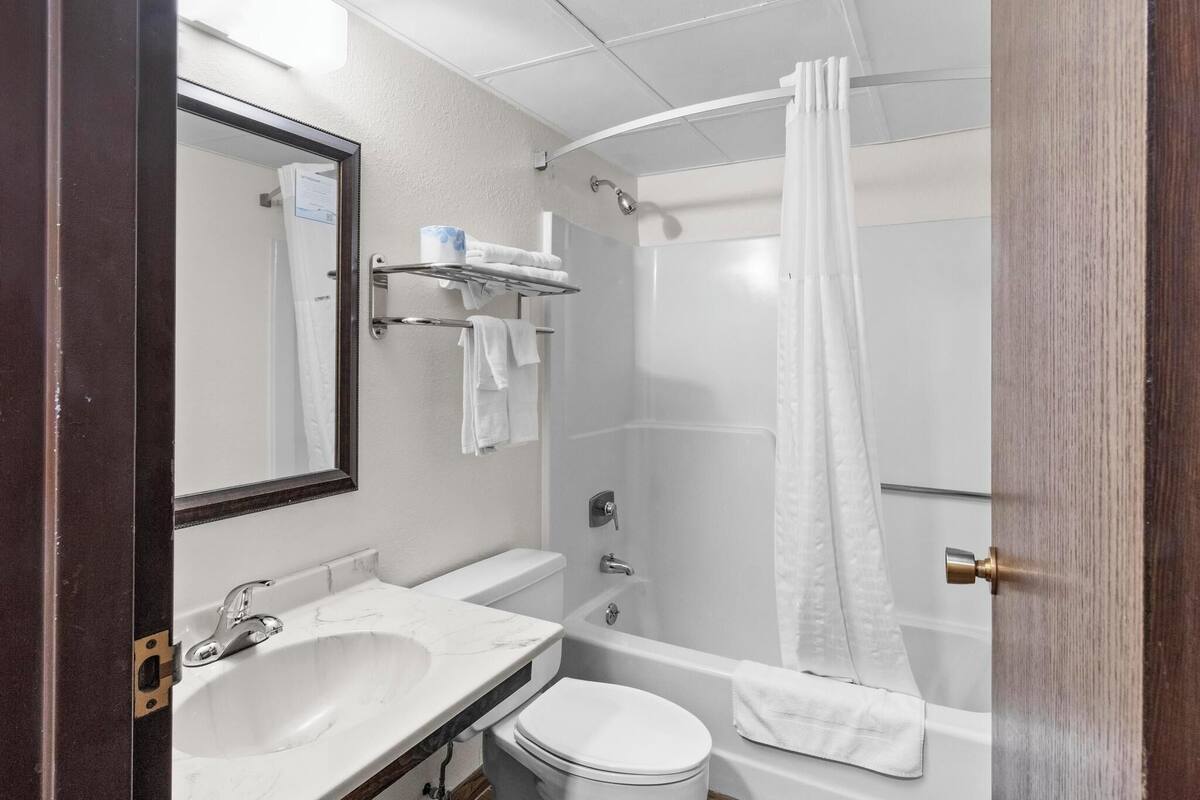 A bathroom with a sink, toilet, and bathtub.