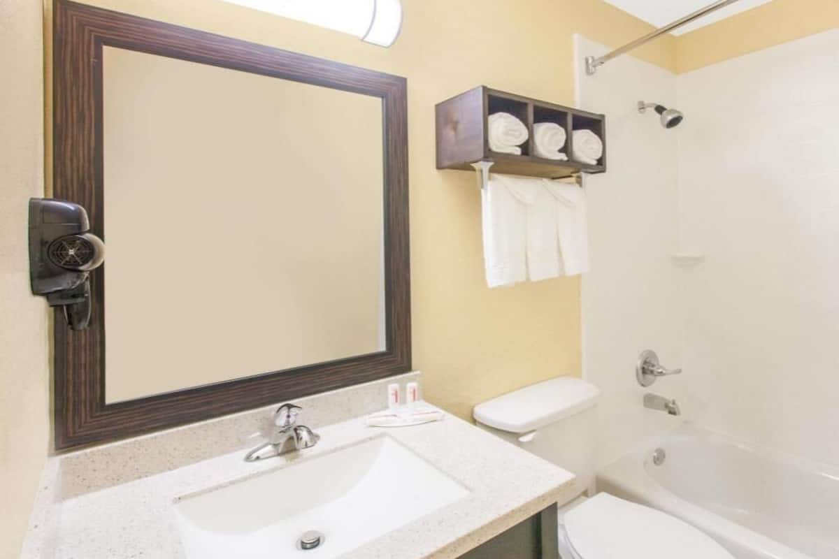 A bathroom with a sink, toilet, and bathtub.