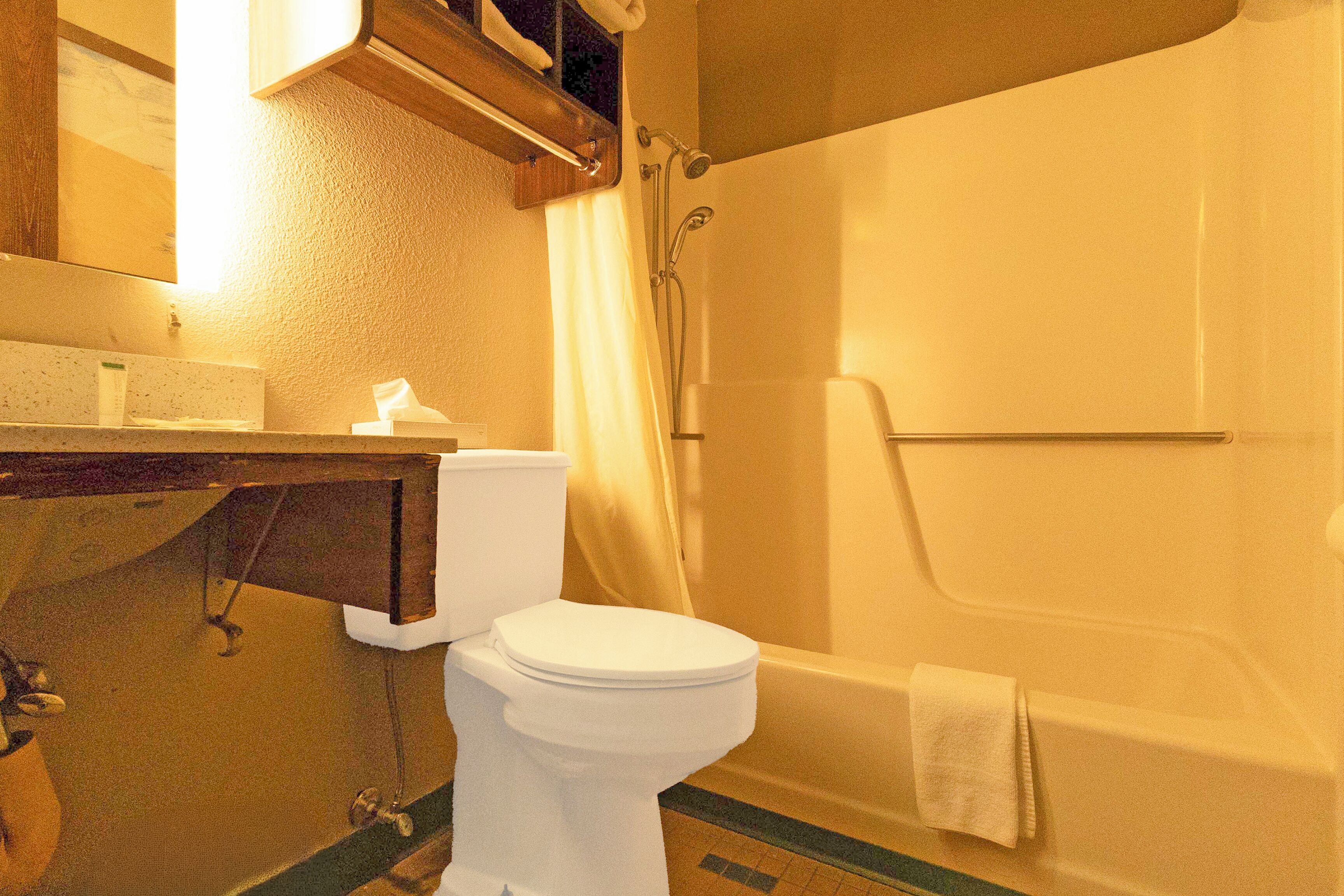A bathroom with a toilet, sink, and bathtub.