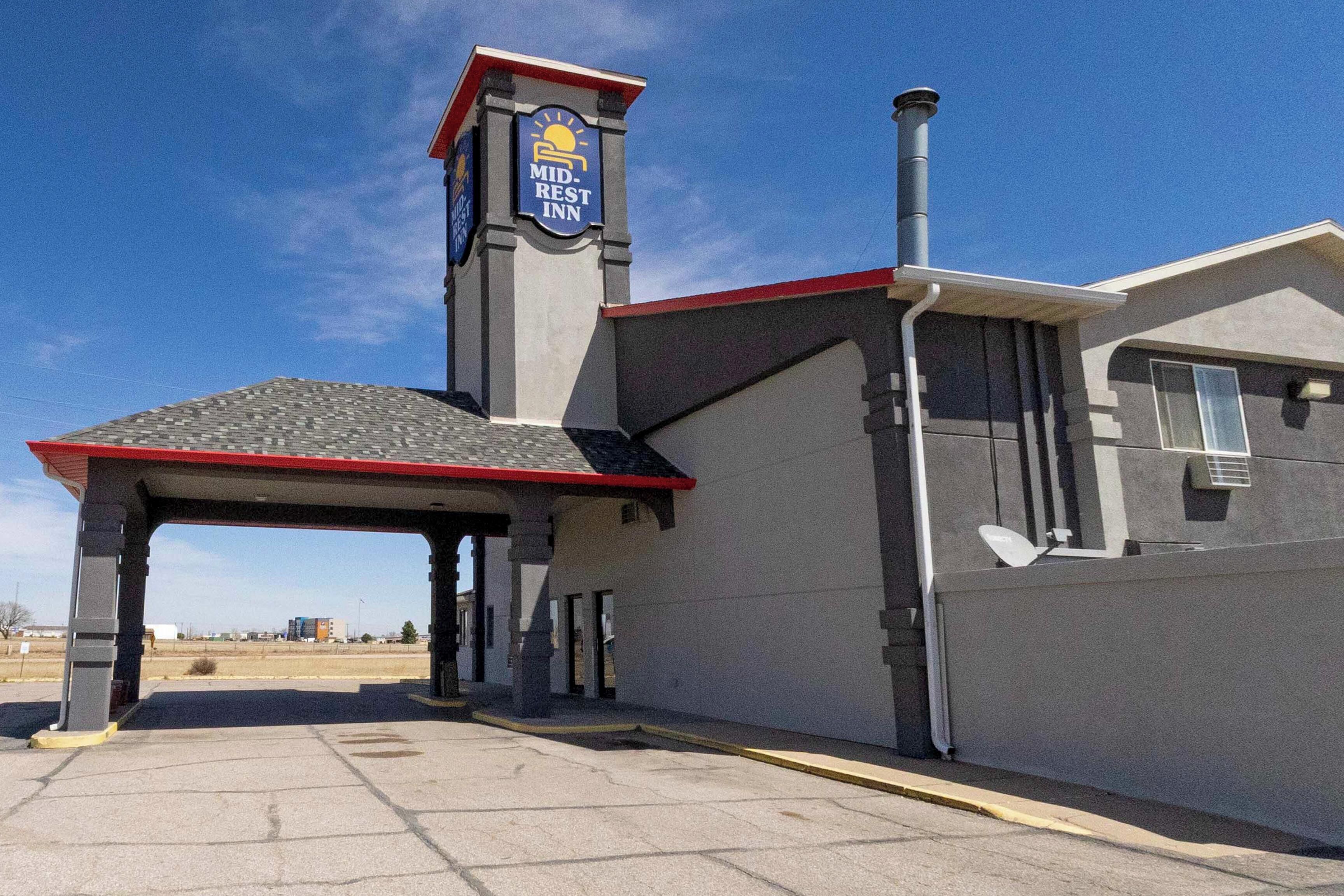 A Mid-REST Inn with a covered entrance, a chimney, and a satellite dish.