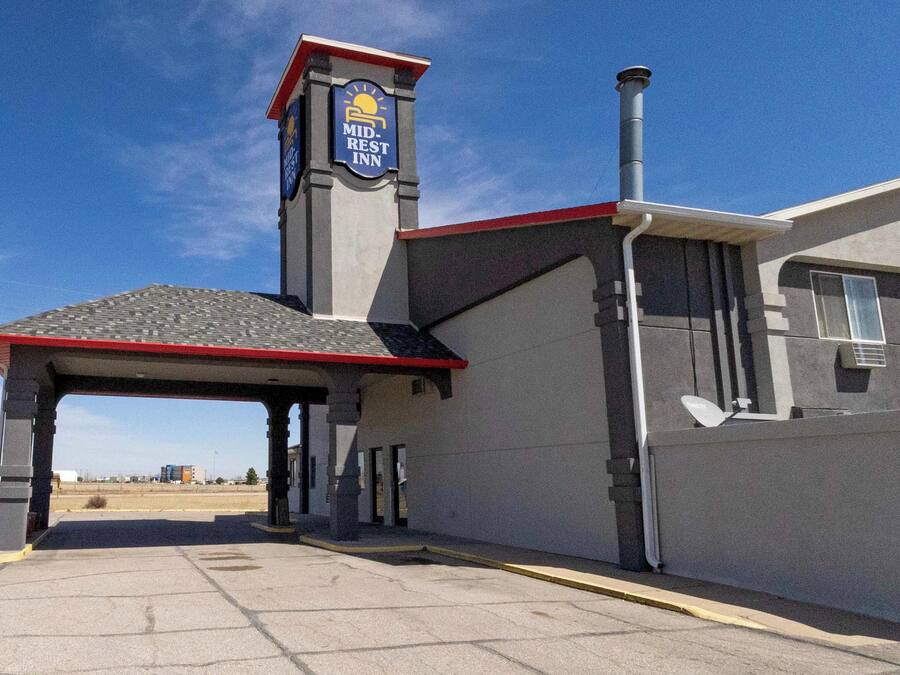 A Mid-REST Inn with a covered entrance, a chimney, and a satellite dish.