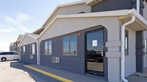 A building with a flat roof, large windows, and a door.